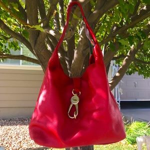 Dooney and Burke logo lock red shoulder bag in new-like condition!